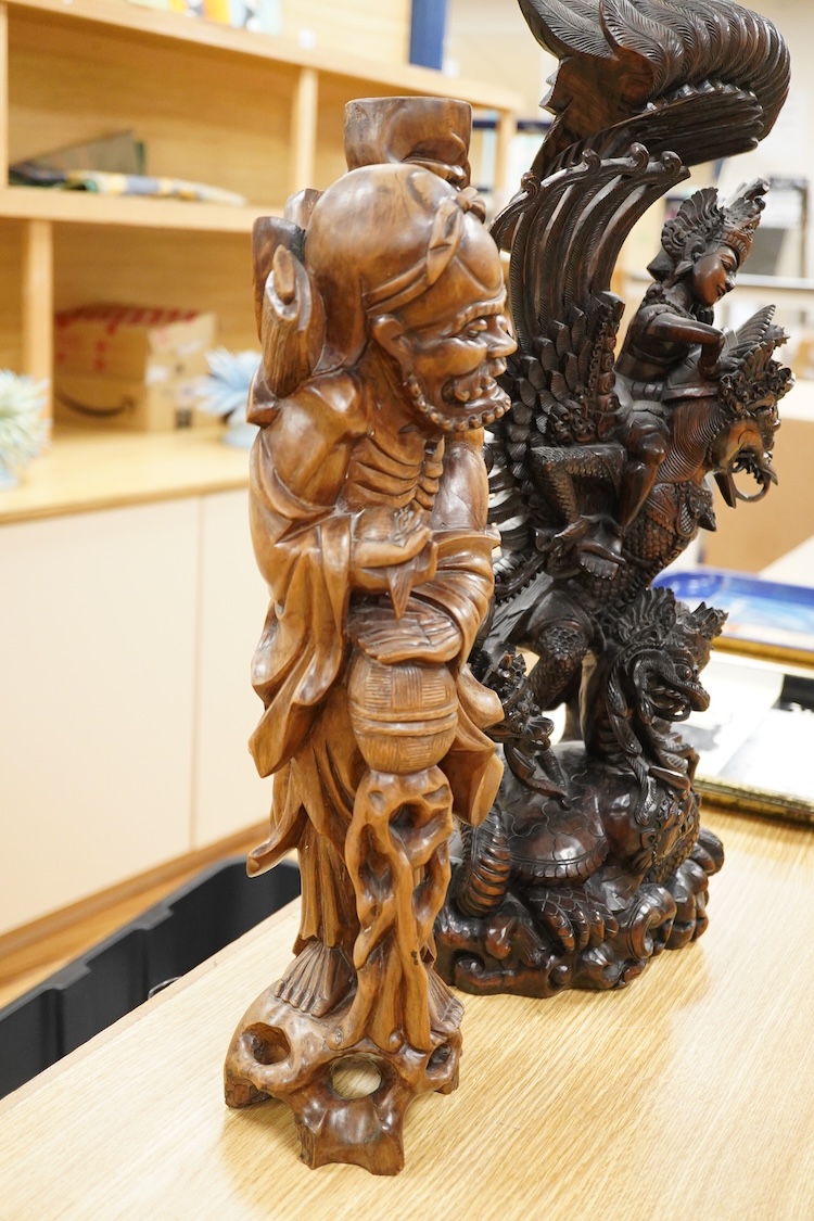 A large Indonesian hardwood Garuda group and a Chinese hardwood figure of a Luohan, largest 61cm high